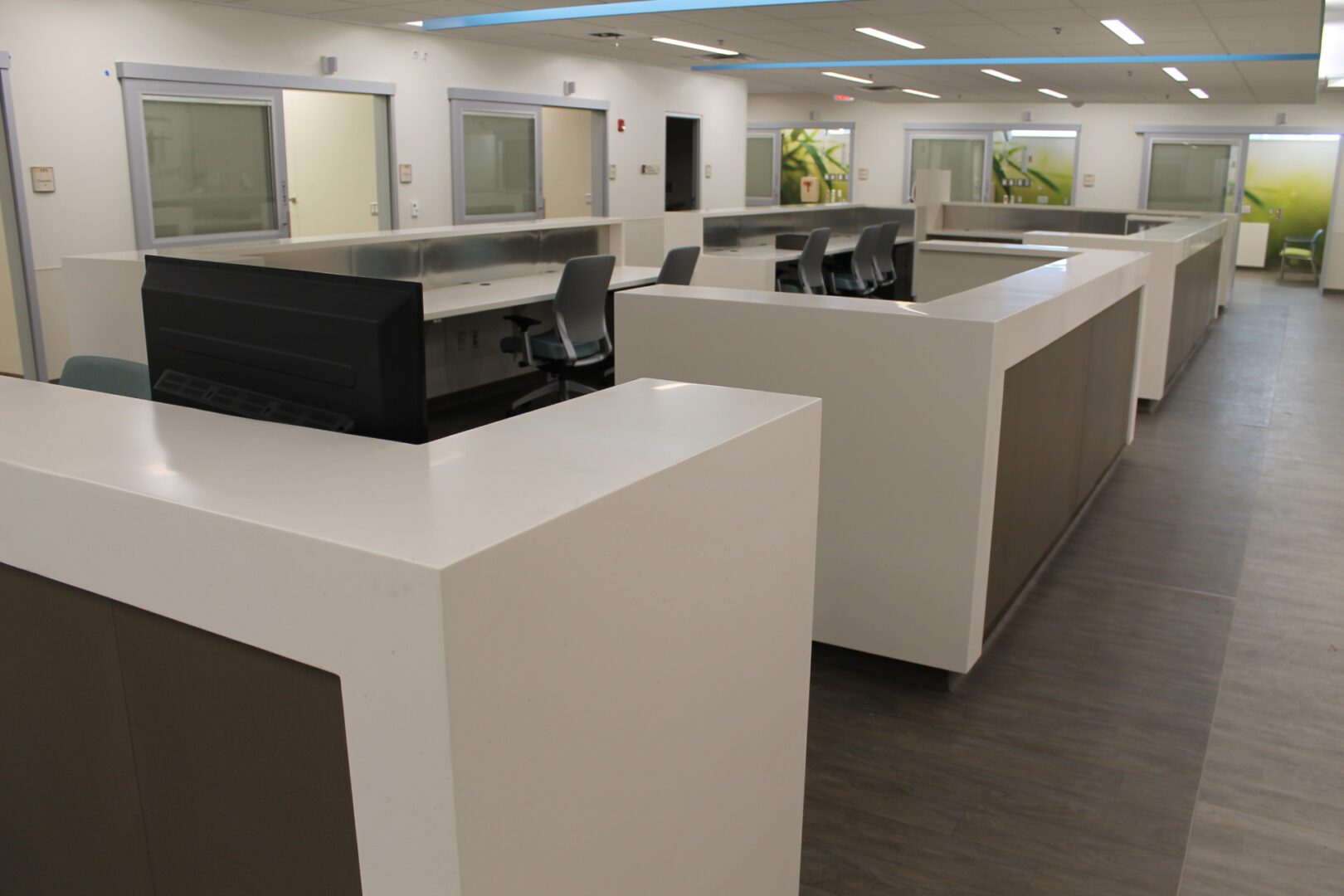 A large white reception desk with black and brown accents.