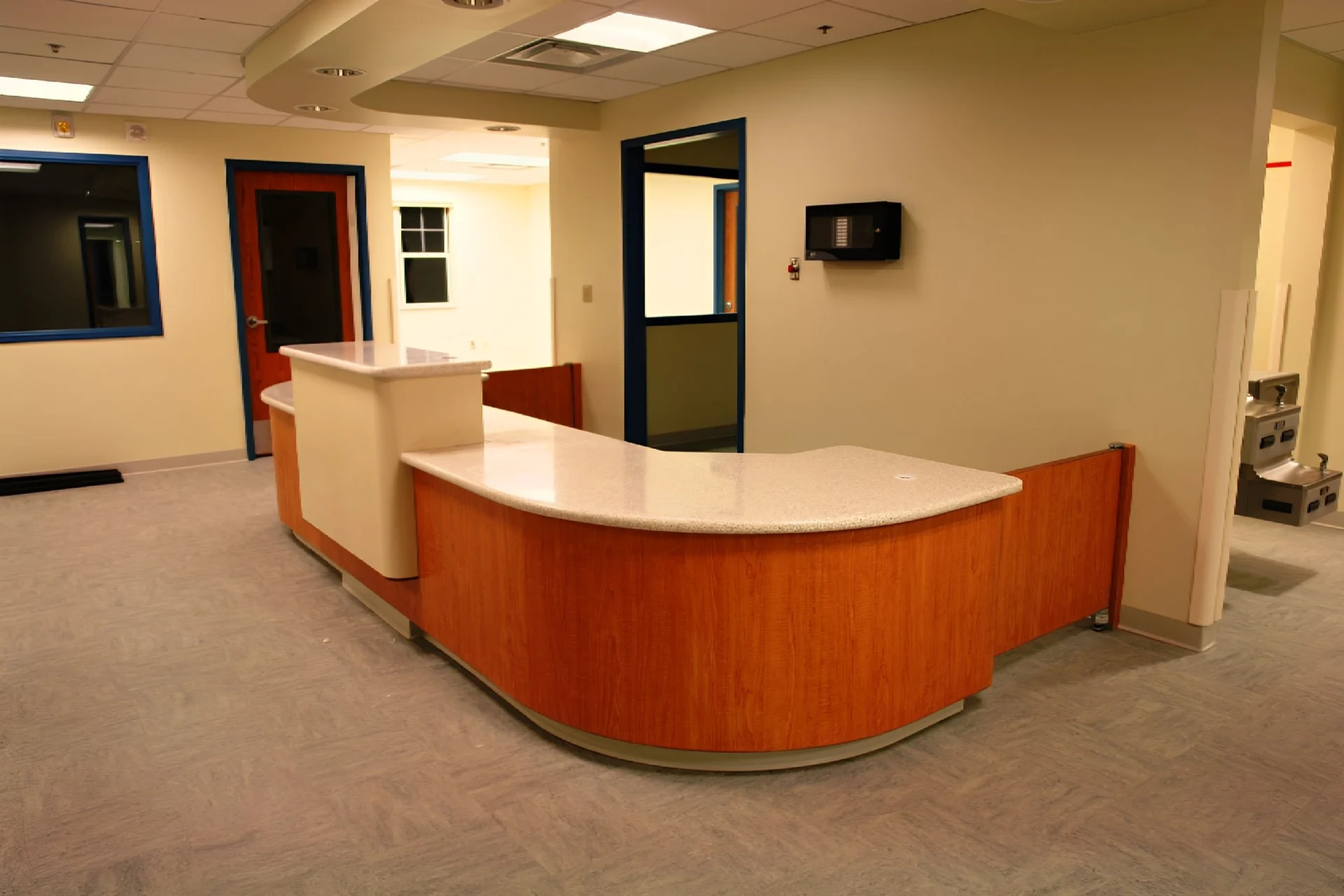 A large reception area with a desk and television.