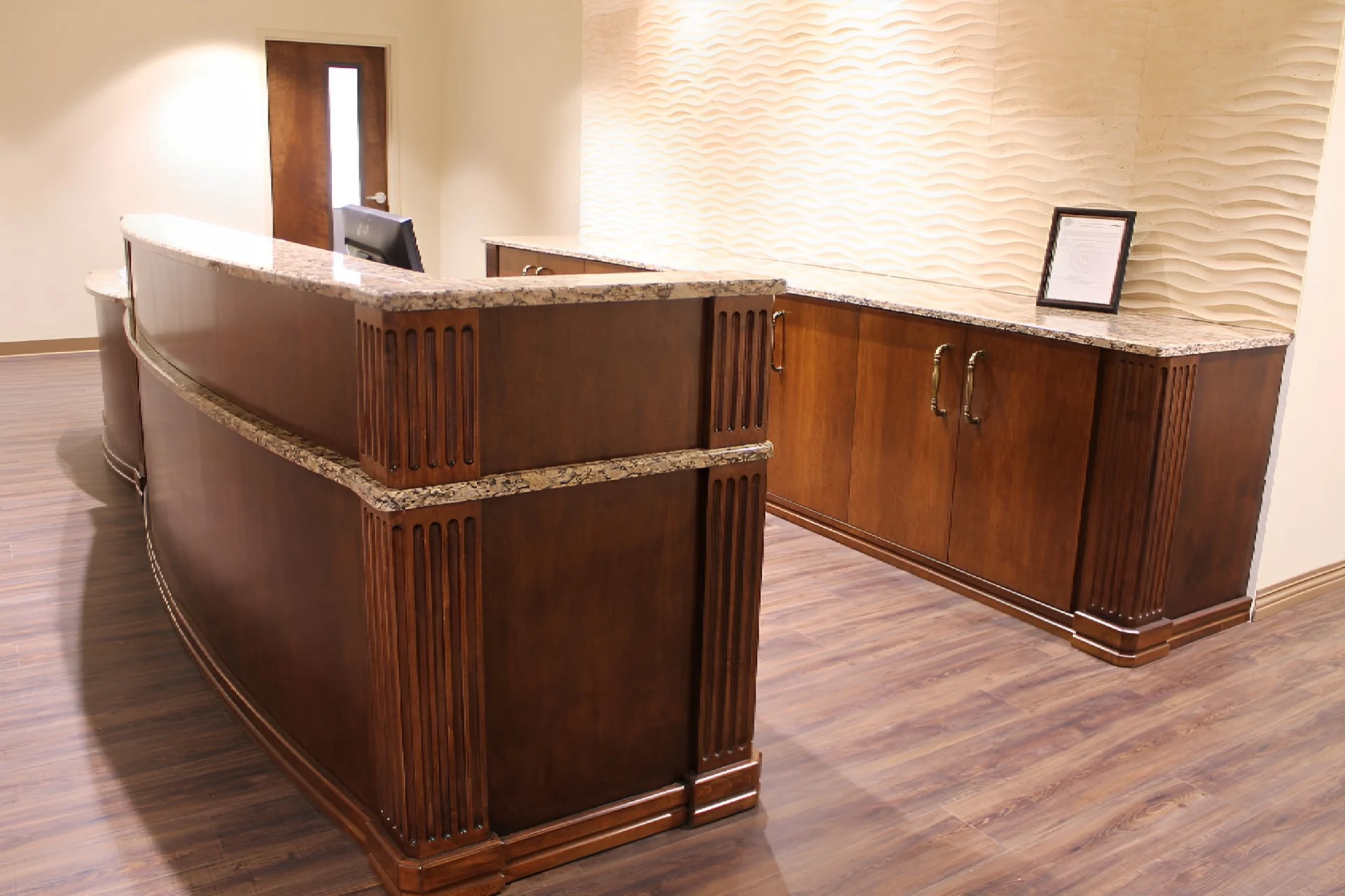 A wooden desk with a computer on top of it.