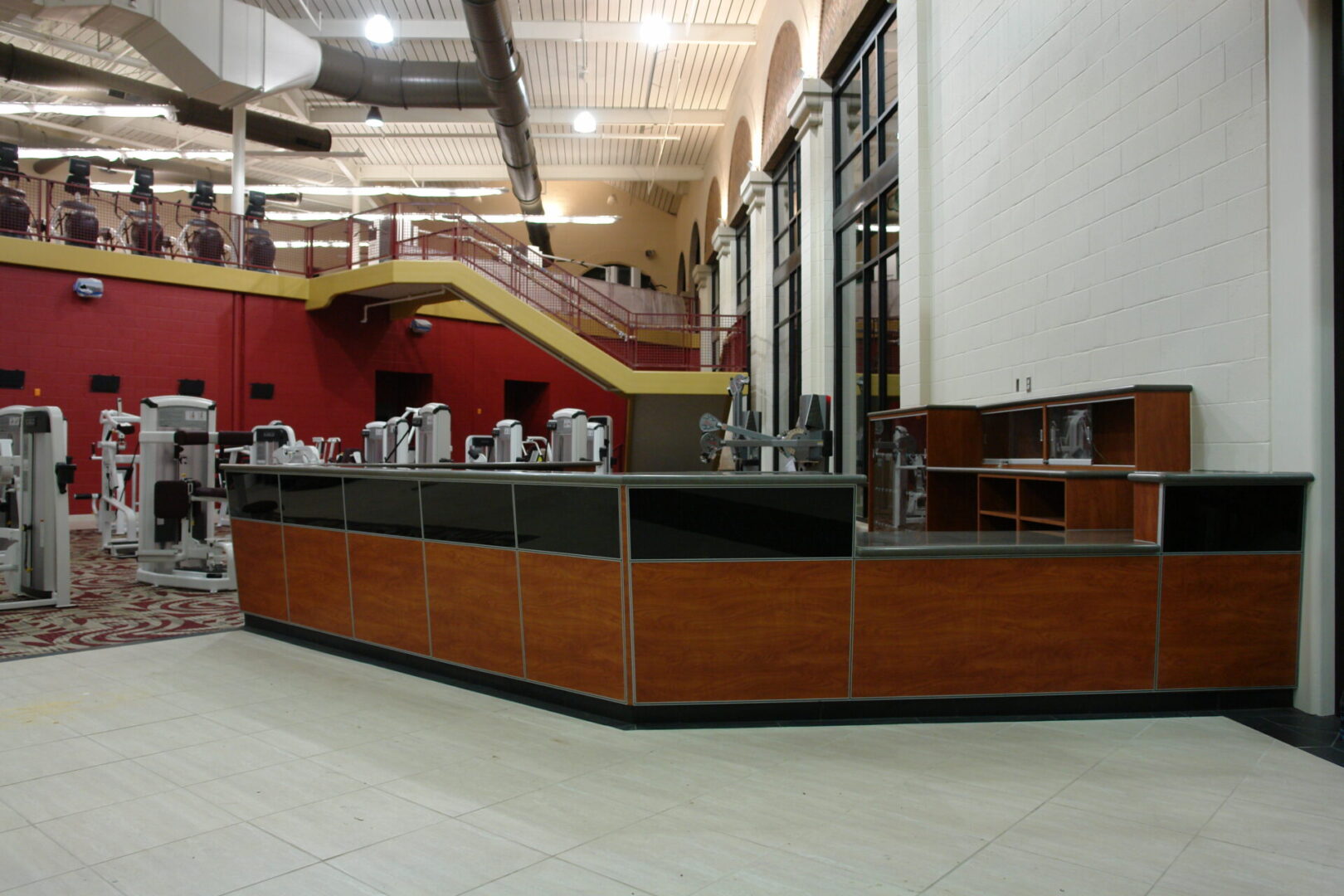 A large counter in an empty room with stairs.